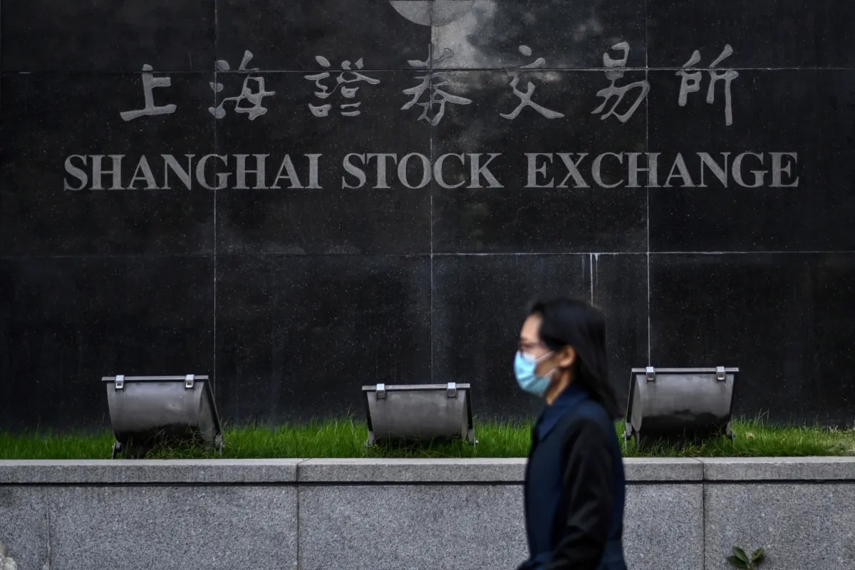 A pedestrian walks past the Shanghai Stock Exchange in Shanghai, China, on Nov. 4, 2020.(Hector Retamal/AFP via Getty Images)
