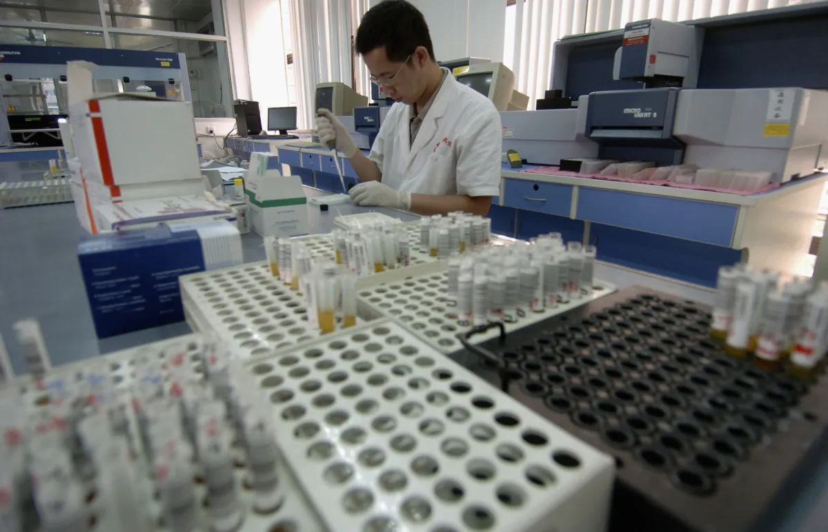 An inspection worker tests blood samples from volunteer donors at the Guangzhou Blood Centre, in Guangzhou, Guangdong Province, China, on June 13, 2005. (China Photos/Getty Images)