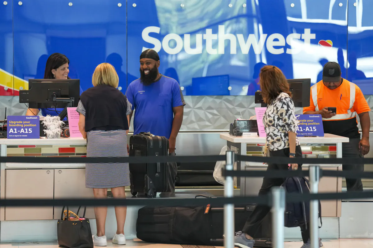 Southwest Airlines ticketing and ramp agents work at a check in desk at Dallas Love Field Airport on July 26, 2022. (Smiley N. Pool/The Dallas Morning News/TNS)