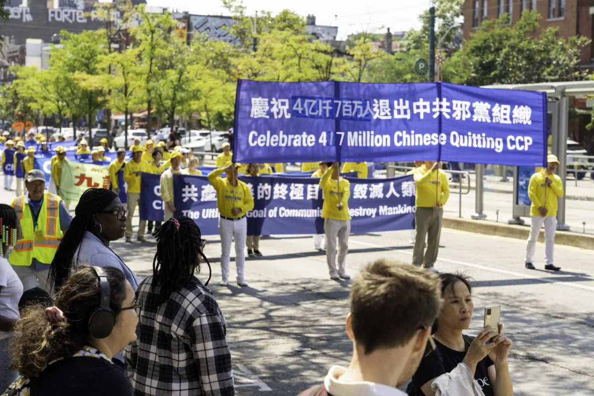 Hundreds of Falun Gong adherents hold a parade in downtown Toronto on Aug. 19, 2023, to celebrate 417 million Chinese people quitting the Chinese Communist Party and its affiliated organizations. (Evan Ning/The Epoch Times)