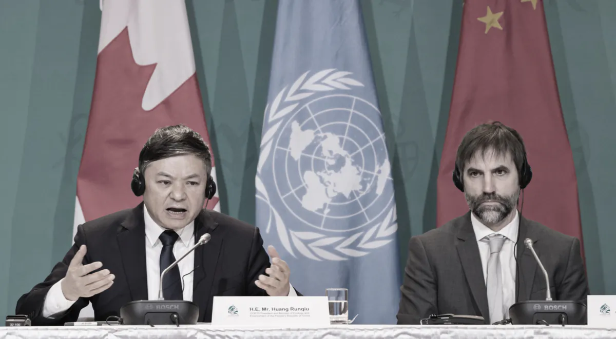 Huang Runqiu, COP15 president and Chinese Ecology and Environment Minister, speaks as Environment Minister Steven Guilbeault looks on during a press conference at the COP15 summit on biodiversity, in Montreal on Dec. 17, 2022. (The Canadian Press/Peter McCabe)