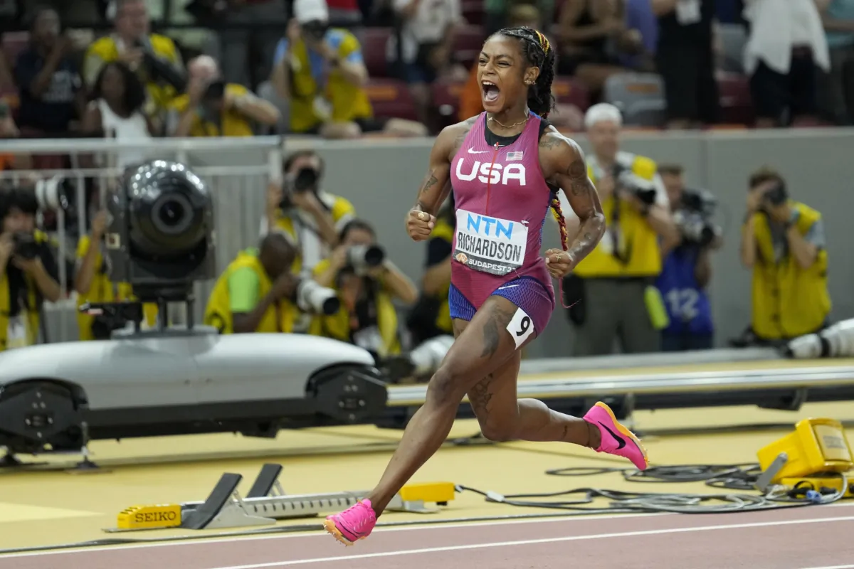 Sha'Carri Richardson, of the United States, reacts after crossing the finish line to win the gold medal in the Women's 100-meter final during the World Athletics Championships in Budapest, Hungary, on Aug. 21, 2023. (Matthias Schrader/AP Photo)