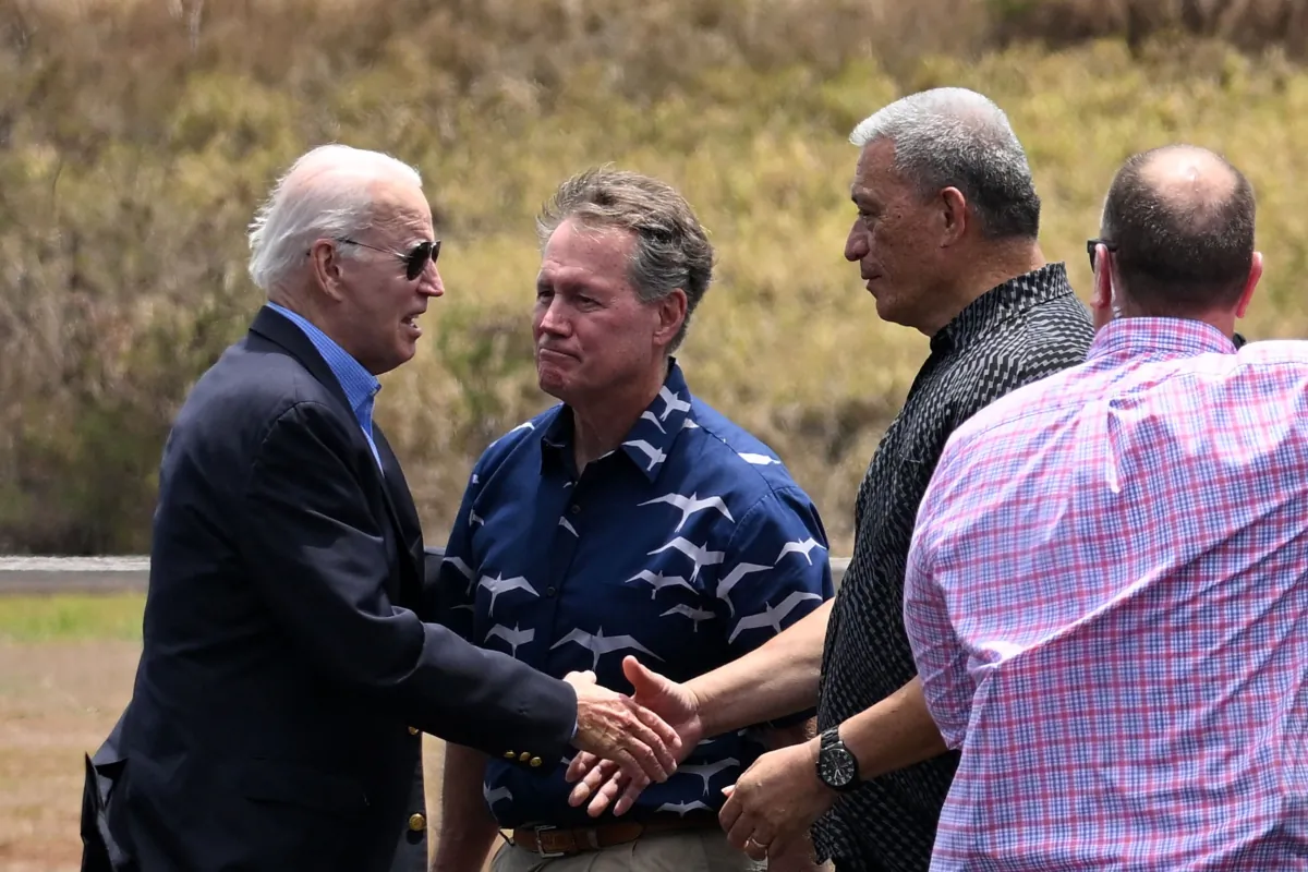 President Joe Biden greets Maui Mayor Richard Bissen (2nd R) and U.S. Rep. Ed Case (D-Hawaii) (C) at Kapalua Airport, Lahaina, Hawaii, on Aug. 21, 2023. The Bidens are expected to meet with first responders, survivors, and local officials following deadly wildfires in Maui. (Mandel Ngan/AFP via Getty Images)
