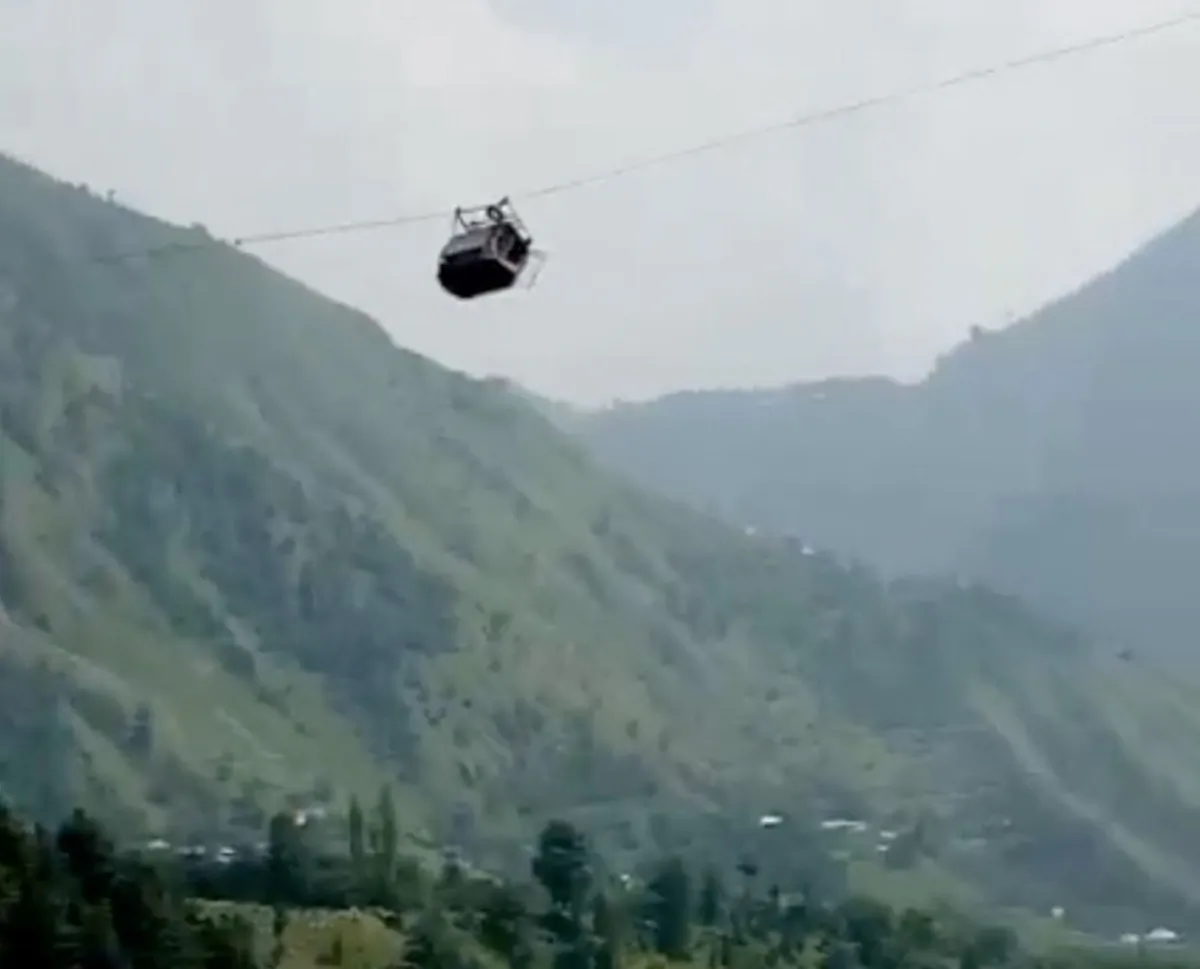 A cable car carrying students is stranded mid-air in Battagram, Pakistan, on Aug. 22, 2023, in this screen grab obtained from social media video. (Umeed Sahar via Reuters)