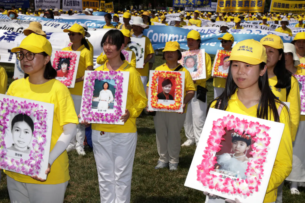 Falun Gong practitioners and supporters hold pictures of victims who were persecuted by the Chinese government as they take part in an annual rally and demonstration at the National Mall in Washington, on July 16, 2021. (Alex Wong/Getty Images)