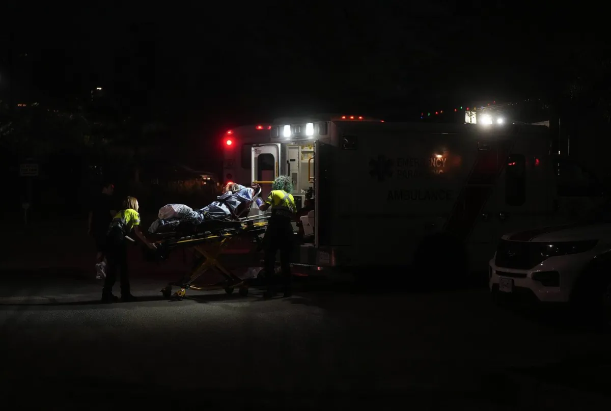 A resident is placed in an ambulance as paramedics assist in the evacuation of a seniors care facility due to wildfires, in Kelowna, B.C., Aug. 18, 2023. (The Canadian Press/Darryl Dyck)
