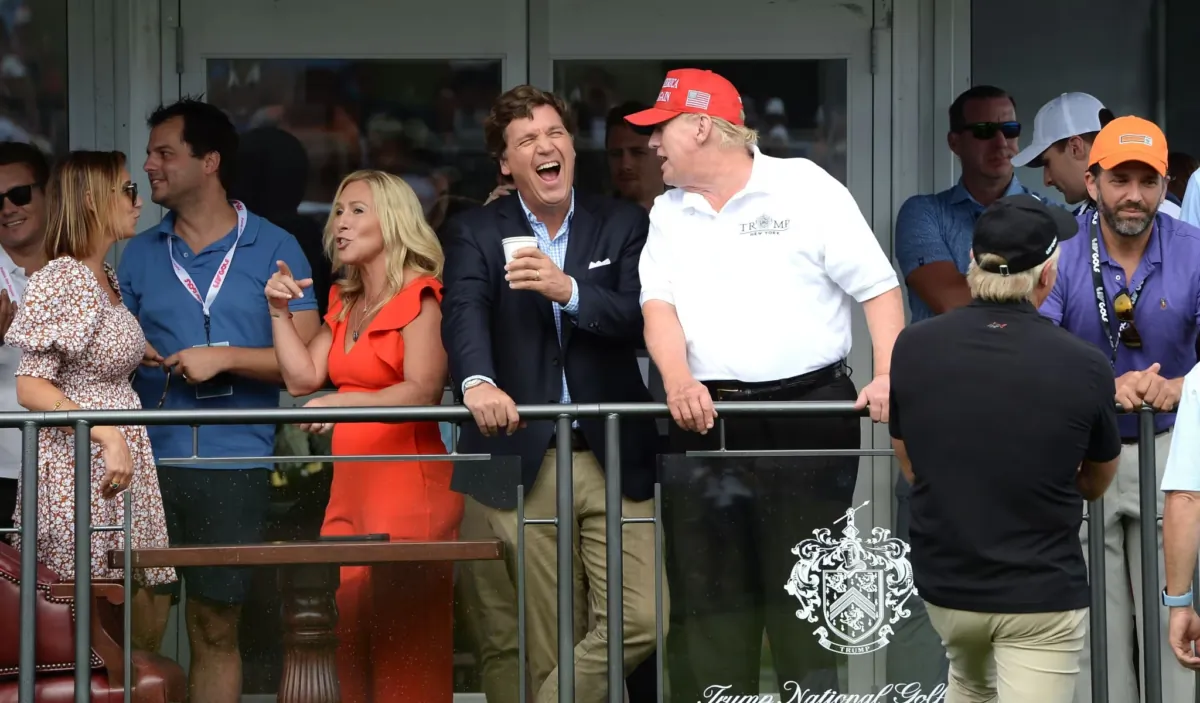 Tucker Carlson (C) jokes with former President Donald Trump (R) during the final LIV Golf Tournament held at the Trump National Golf Club in Bedminster, N.J., on July 31, 2022. (L.E.MORMILE/Shutterstock)