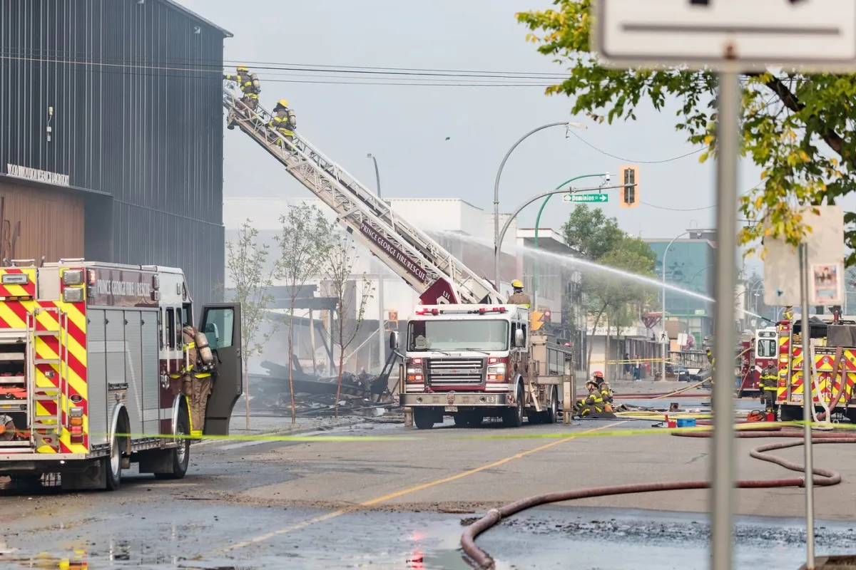Prince George fire crews attend to a structure fire caused by an explosion in downtown Prince George, B.C., on Aug. 22, 2023. (The Canadian Press/James Doyle)