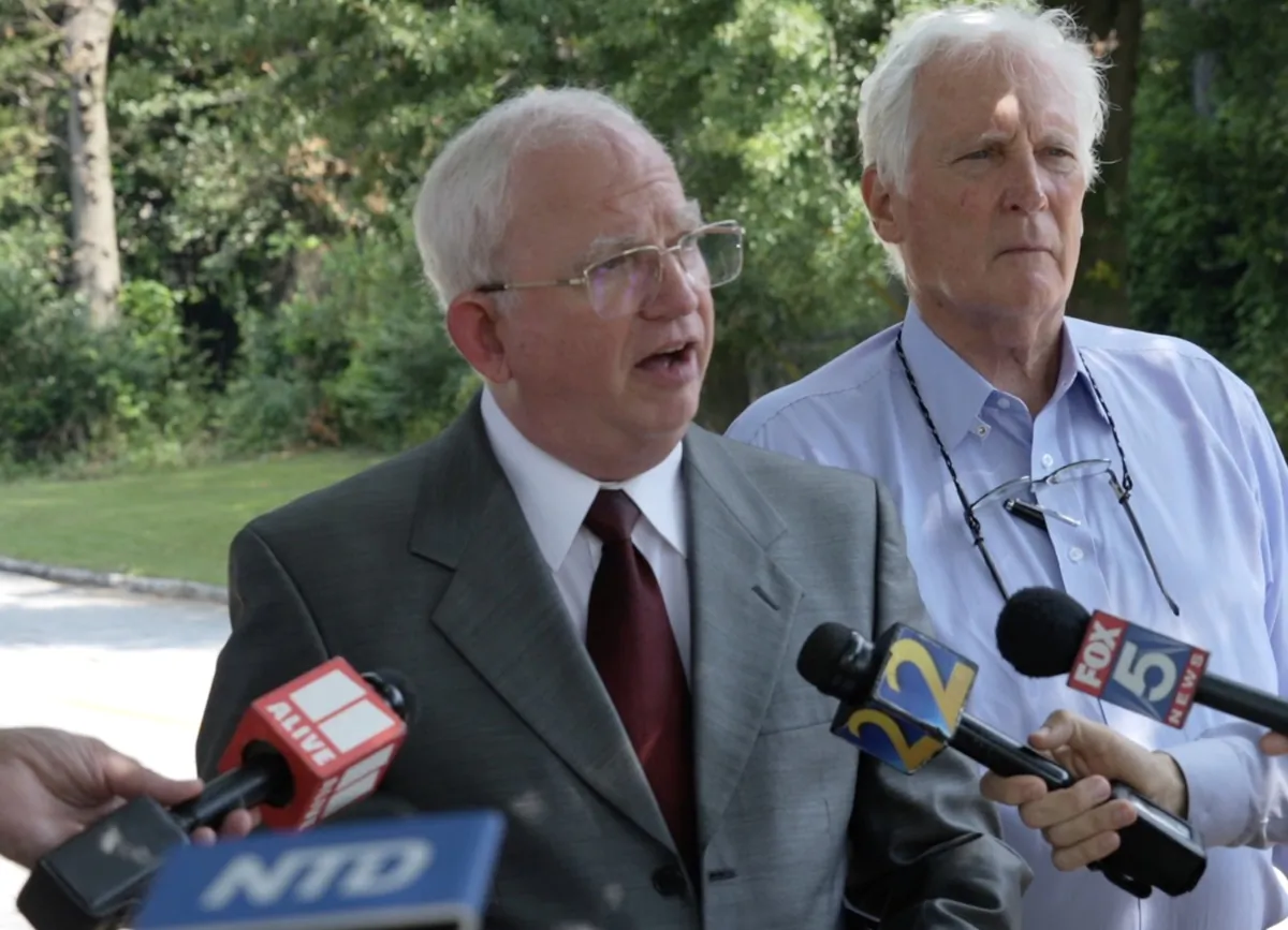 John Eastman (L), former attorney and adviser for former President Donald Trump, speaks with reporters along with his attorney, L. David Wolfe, outside the Fulton County Jail on Aug. 22, 2023, in a still from video. (NTD/Screenshot via The Epoch Times)