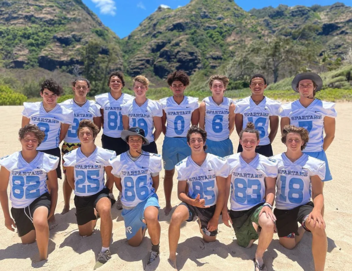 The Villa Park High School football team's wide receivers pose for a group photo during a season-opening trip in Oahu, Hawaii, on Aug. 11, 2023. (Courtesy of Dusan Ancich via Instagram/Screenshot via The Epoch Times)