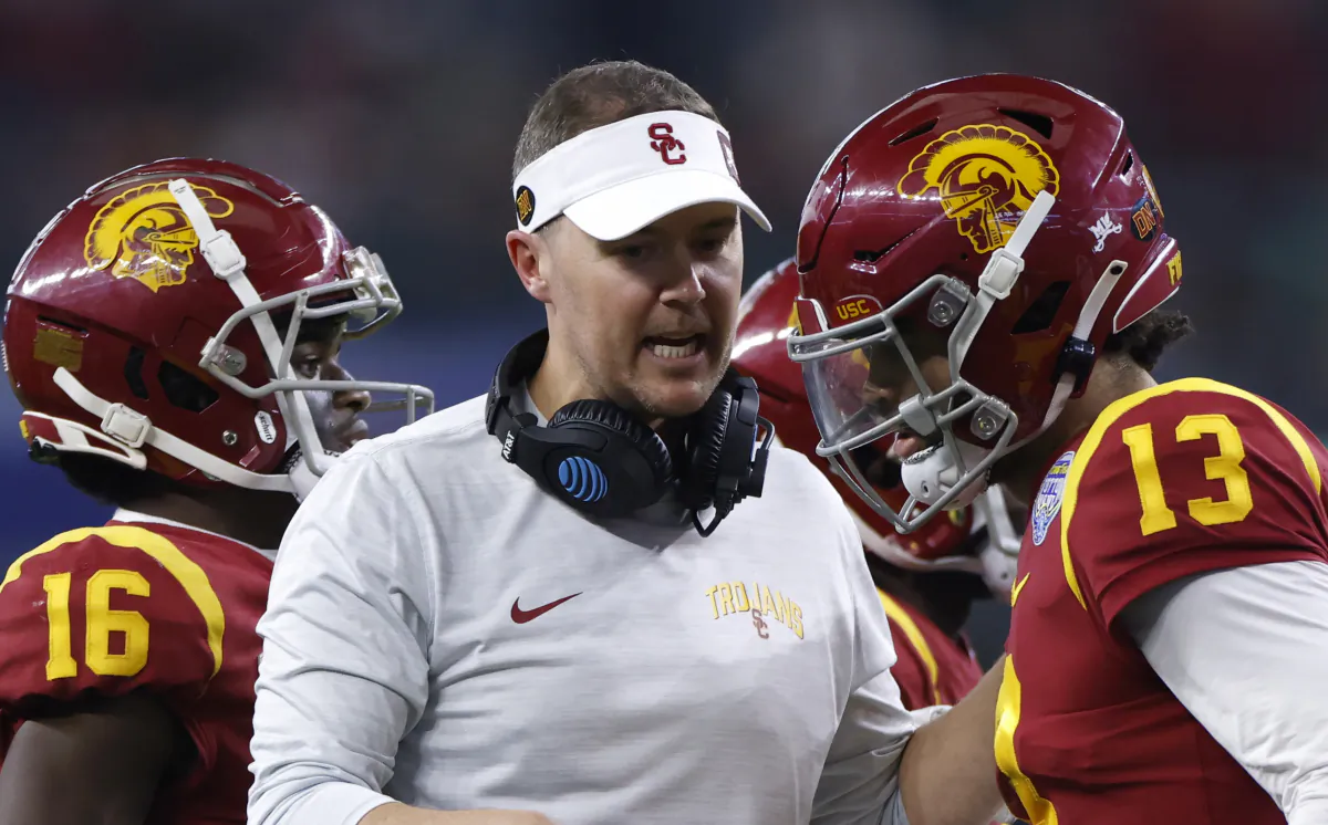 Head coach Lincoln Riley of the USC Trojans talks with quarterback Caleb Williams (13) as USC lost 45–46 to the Tulane Green Wave, in the second half of the Goodyear Cotton Bowl Classic at AT&T Stadium in Arlington, Texas, on Jan. 2, 2023. (Ron Jenkins/Getty Images)
