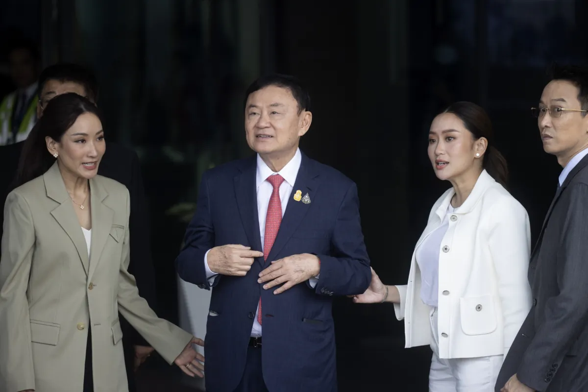Thailand's former Prime Minister Thaksin Shinawatra (2nd L) walks with his son Panthongtae, his daughters Pinthongta and Paetongtarn (2nd R) as he arrives at Don Muang airport in Bangkok, Thailand, on Aug. 22, 2023. (Wason Wanichakorn/AP Photo)