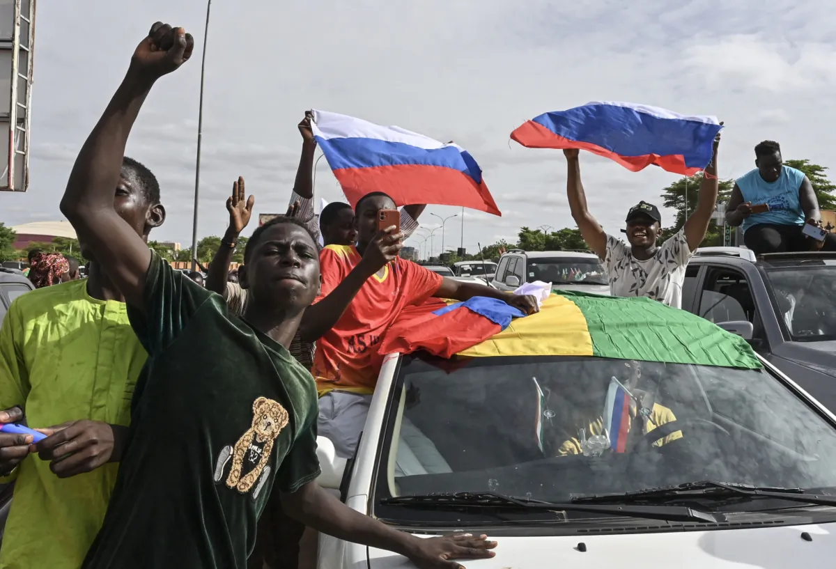 Supporters of Niger's National Council for the Safeguard of the Homeland (CNSP) wave Russian flags as they demonstrate in Niamey, Niger, on Aug. 6, 2023. (AFP via Getty Images)