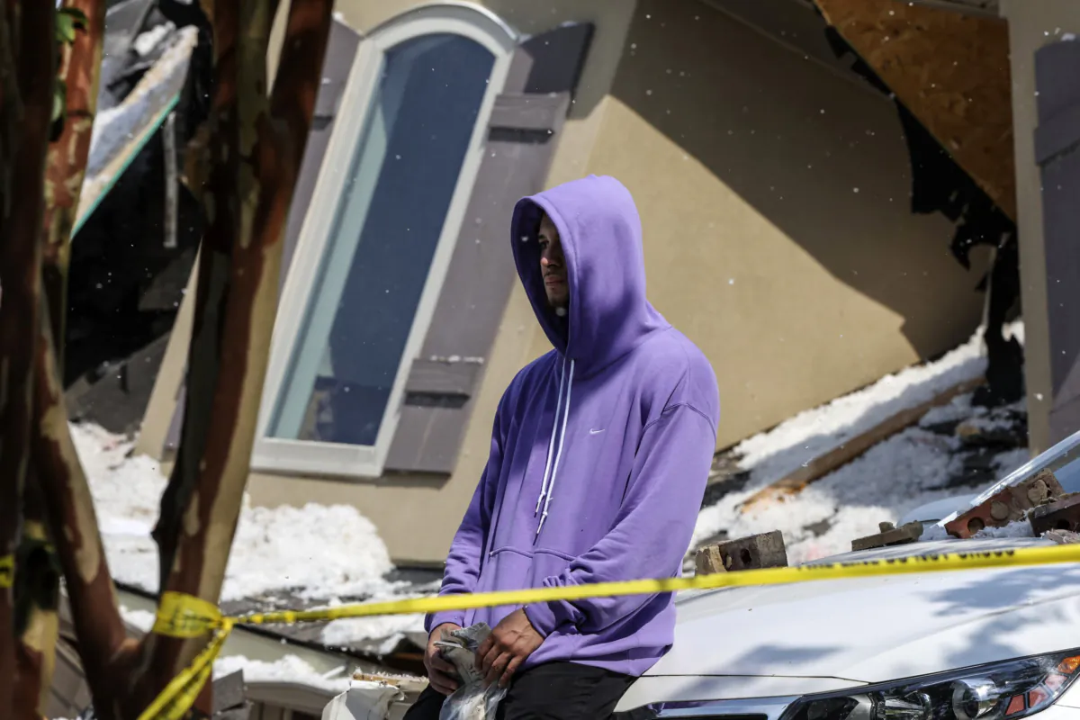 Tennessee Titans cornerback Caleb Farley sits outside of the rubble of his home after an explosion in Mooresville, N.C., on Aug. 22, 2023. (Melissa Melvin-Rodriguez/The Charlotte Observer via AP)
