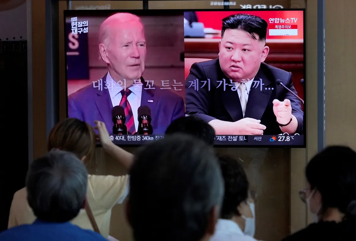 U.S. President Joe Biden (L), and North Korean leader Kim Jong Un during a news program reporting on American soldier Travis King, at the Seoul Railway Station in Seoul, South Korea, on July 22, 2023. (Ahn Young-joon/ AP Photo)