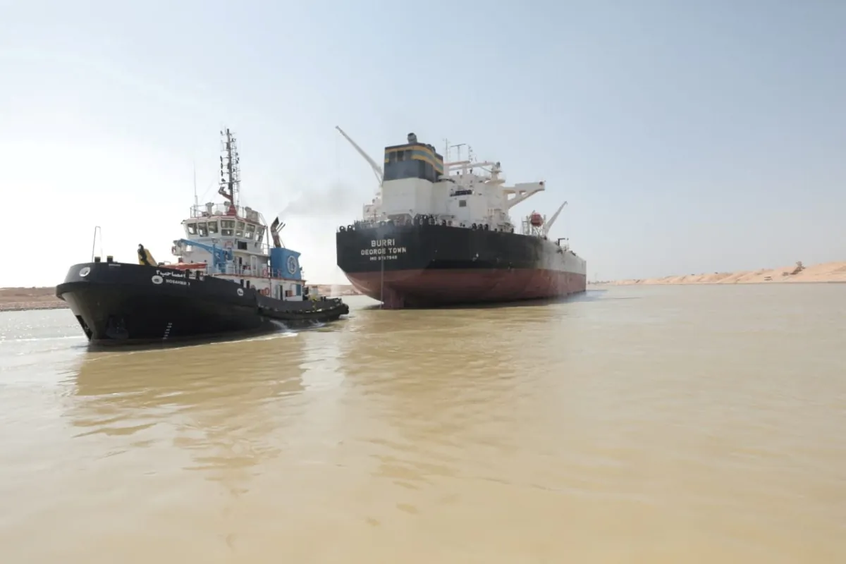 A tugboat works to refloat the Oil Products Tanker BURRI after it collided with LNG Tanker BW Lesmes in the waterway of the Suez Canal, Egypt, on Aug. 23, 2023. (Suez Canal Authority/Handout via Reuters)