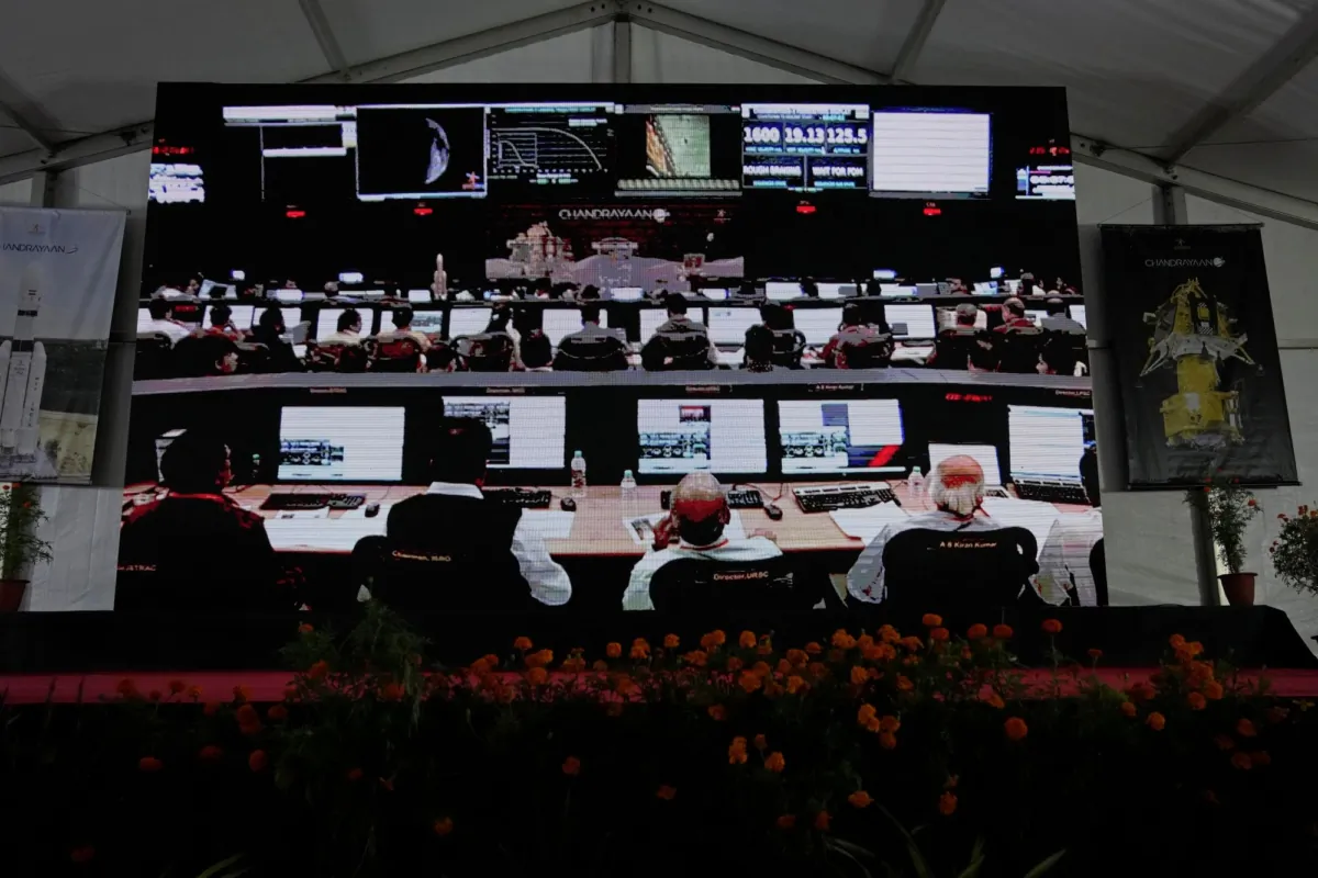Indian Space Research Organization (ISRO) scientists are projected on a screen waiting for the landing of spacecraft Chandrayaan-3 on the moon at ISRO's Telemetry, Tracking and Command Network facility in Bengaluru, India, on Aug. 23, 2023. (Aijaz Rahi/AP Photo)