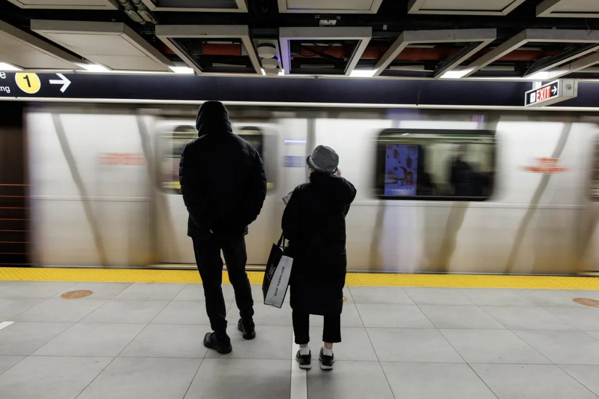 People wait inside a Toronto Transit Commission station in downtown Toronto, on April 1, 2023. (The Canadian Press/Cole Burston)