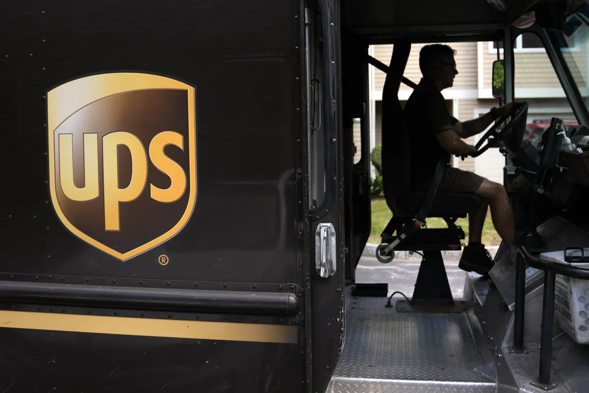 United Parcel Service driver Hudson de Almeida steers through a neighborhood while delivering packages in Haverhill, Mass., on June 30, 2023. (Charles Krupa/AP Photo)