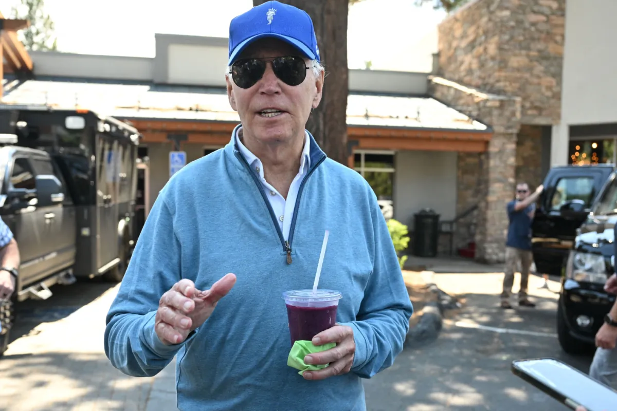 President Joe Biden speaks to reporters after taking a pilates class followed by a spin class with First Lady Jill Biden and members of their family in South Lake Tahoe, Calif., on Aug. 23, 2023. (Mandel Ngan/AFP via Getty Images)