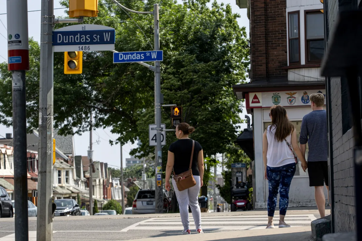 Pedestrians wait to cross an intersection on Dundas Street West in Toronto on June 10, 2020. (The Canadian Press/Giordano Ciampini)