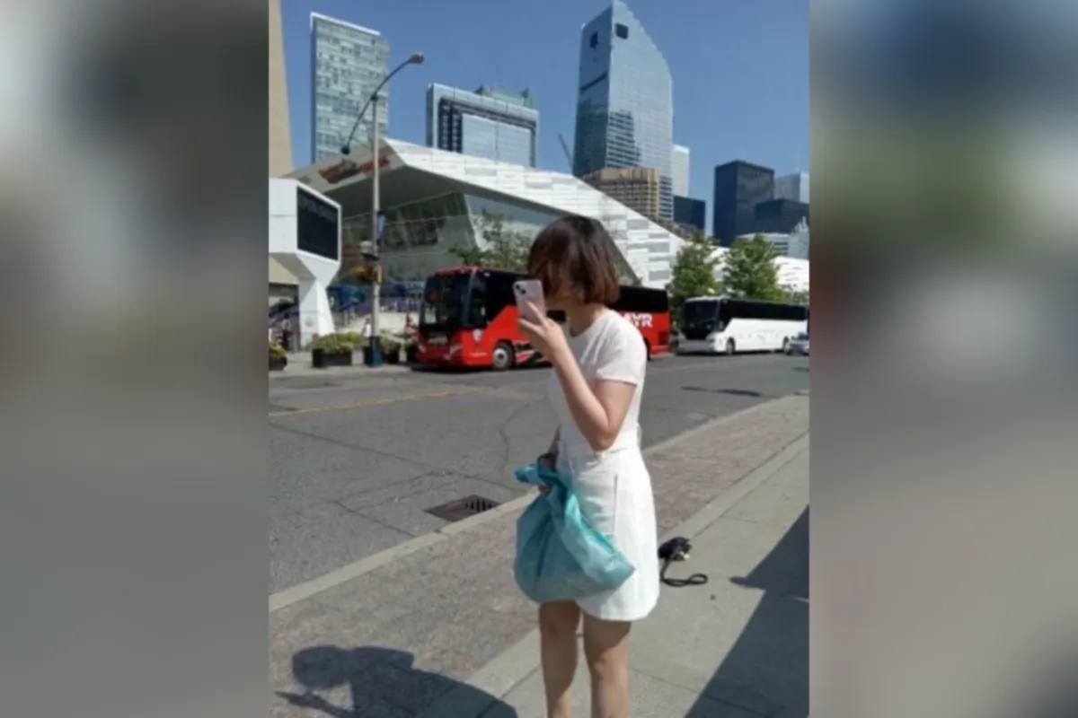 A woman has been arrested after allegedly threatening, harassing Zhou Chuangying, a 78-year-old Falun Gong adherent, near CN Tower on Aug. 20, 2023. (Courtesy of Zhou Chuangying)