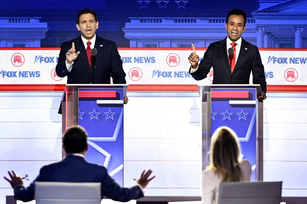 Florida Governor Ron DeSantis and entrepreneur and author Vivek Ramaswamy speak during the first Republican Presidential primary debate at the Fiserv Forum in Milwaukee, Wisconsin, on Aug. 23, 2023. (Brendan Smialowski/AFP via Getty Images)
