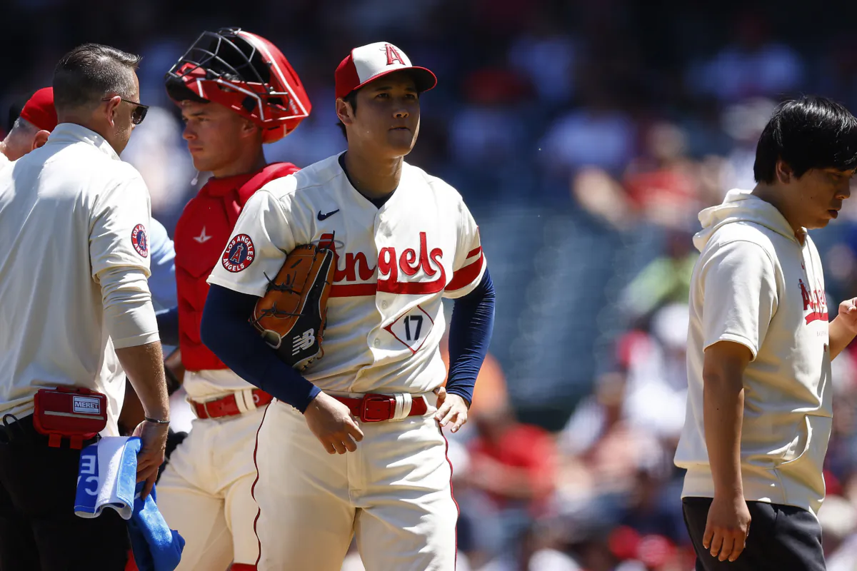 Shohei Ohtani (17) of the Los Angeles Angels leaves the game against the Cincinnati Reds in the second inning during game one of a doubleheader at Angel Stadium of Anaheim in Anaheim, Calif., on Aug. 23, 2023 (Ronald Martinez/Getty Images)