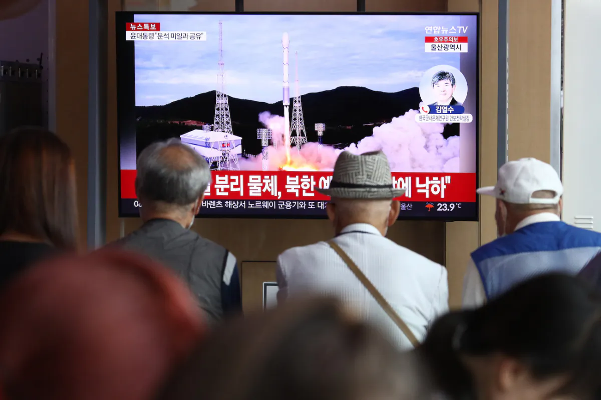 People watch a television broadcast showing a file image of a North Korean rocket launch, at the Seoul Railway Station in Seoul, South Korea, on Aug. 24, 2023. (Chung Sung-Jun/Getty Images)