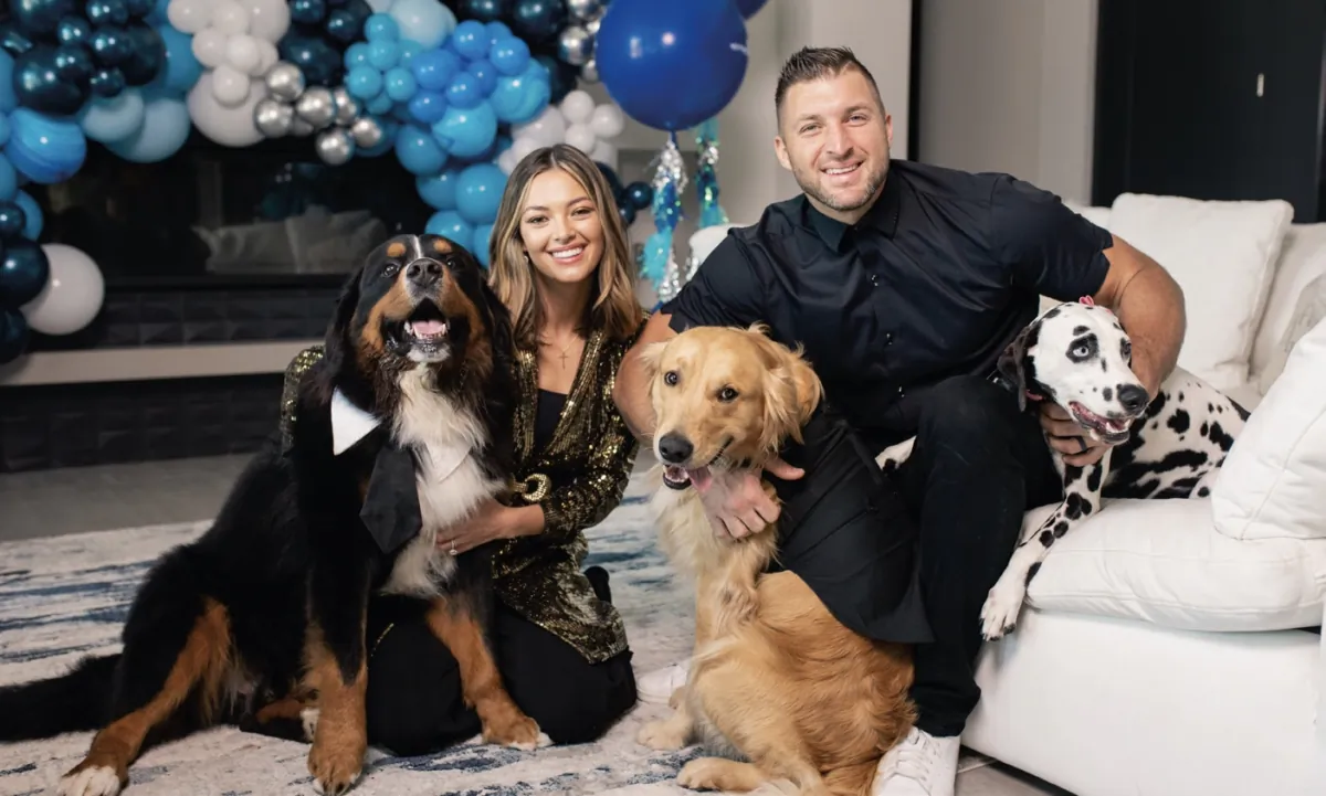 Tim Tebow and his wife Demi-Leigh with their beloved dogs, from left to right: Chunk,
Kobe, and Paris. (Mary Benson)
