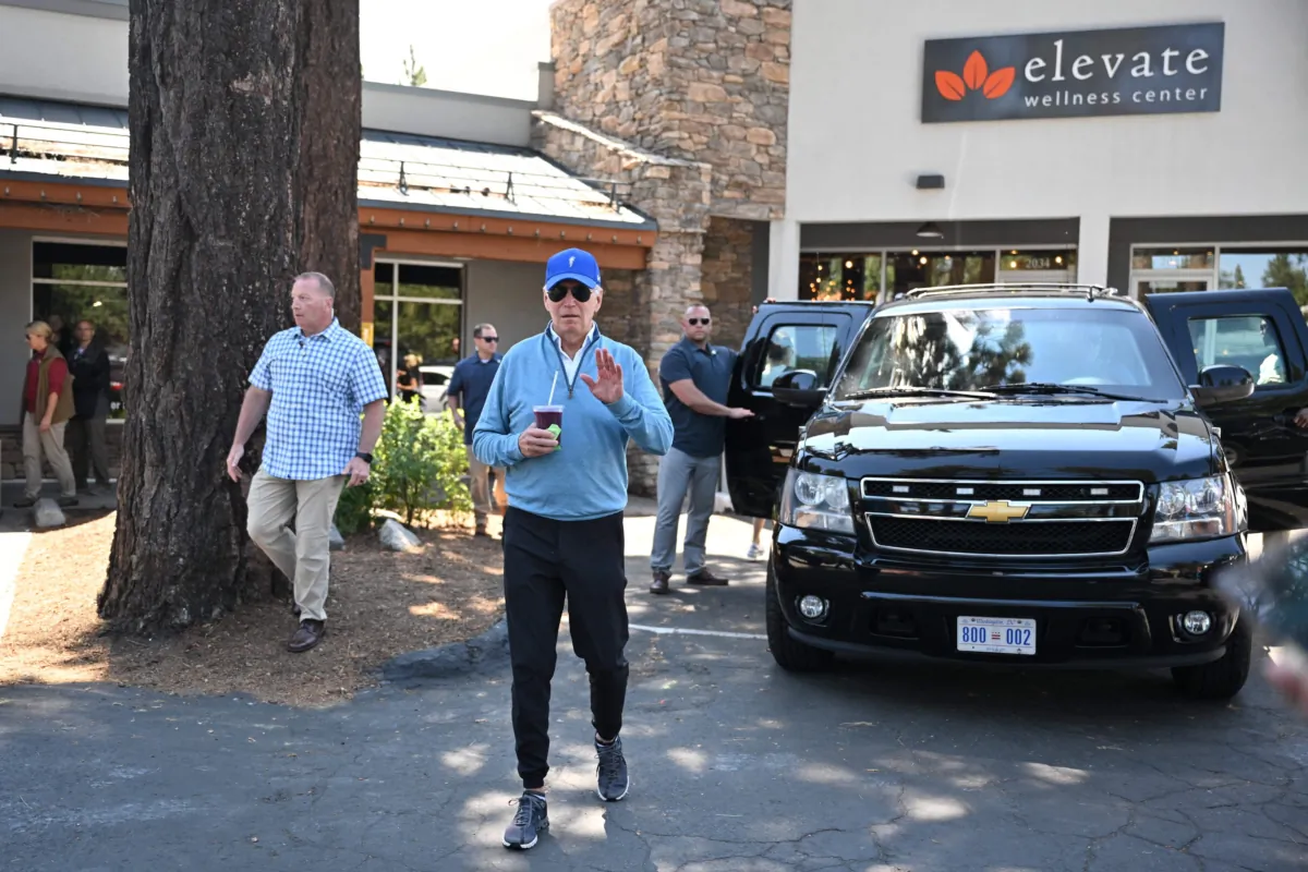 President Joe Biden speaks to reporters after taking a pilates class followed by a spin class with First Lady Jill Biden and members of their family in South Lake Tahoe, Calif., on Aug. 23, 2023. (Mandel Ngan/AFP via Getty Images)