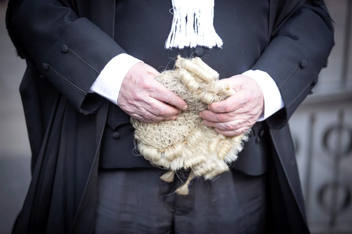A Scottish advocate carries his wig outside Edinburgh Sheriff Court in Edinburgh, Scotland on Jan. 23, 2000. (PA) 
