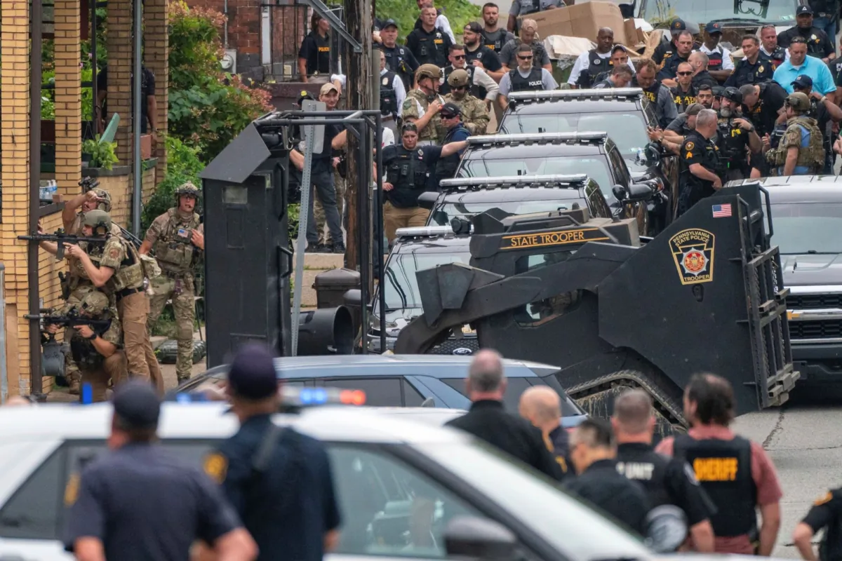 Pittsburgh police prepare to deploy an armored vehicle with a ramming device as they and other law personnel respond to an active shooter situation in the Garfield neighborhood of Pittsburgh on Aug. 23, 2023. (Benjamin B. Braun/Pittsburgh Post-Gazette via AP)