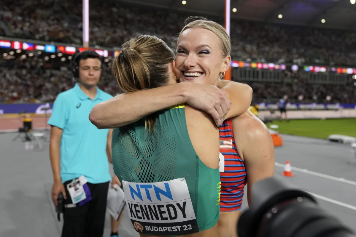 Katie Moon, of the United States, and Nina Kennedy, of Australia, left hug each other after sharing the gold medal in the Women's pole vault final during the World Athletics Championships in Budapest, Hungary, on Aug. 23, 2023. (Matthias Schrader/AP Photo)