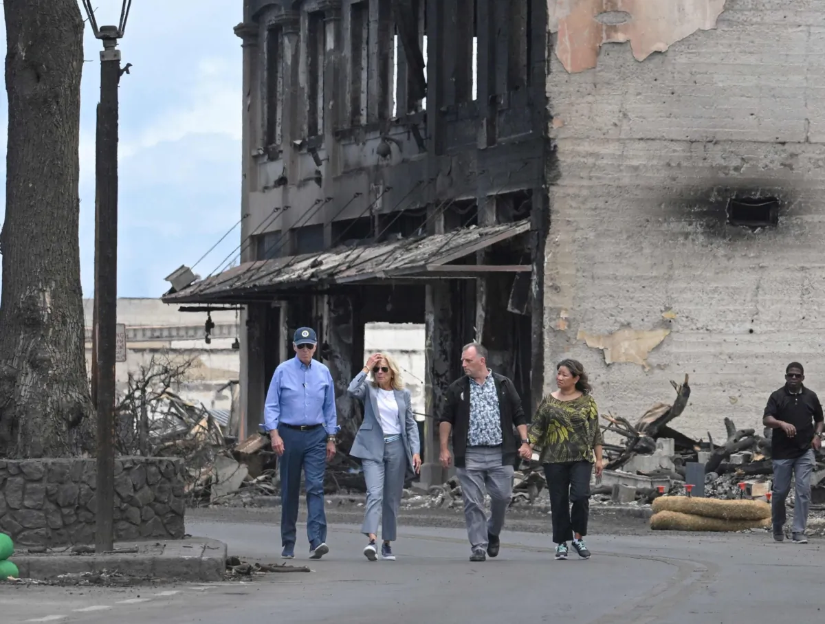 (L-R) US President Joe Biden, First Lady Jill Biden, Hawaii Governor Josh Green, and wife Jaime Green walk along Front Street to inspect wildfire damage in Lahaina, Hawaii on August 21, 2023. The Bidens are expected to meet with first responders, survivors, and local officials following deadly wildfires in Maui. (Photo by Mandel NGAN / AFP) (Photo by MANDEL NGAN/AFP via Getty Images)