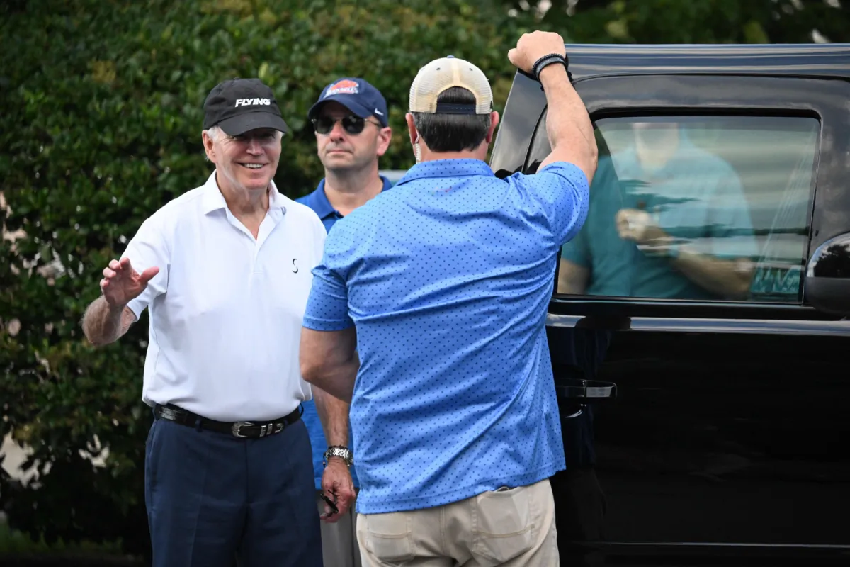President Joe Biden waves as he leaves after spending time at Rehoboth Beach, in Delaware on Aug. 13, 2023. (Photo by MANDEL NGAN/AFP via Getty Images)