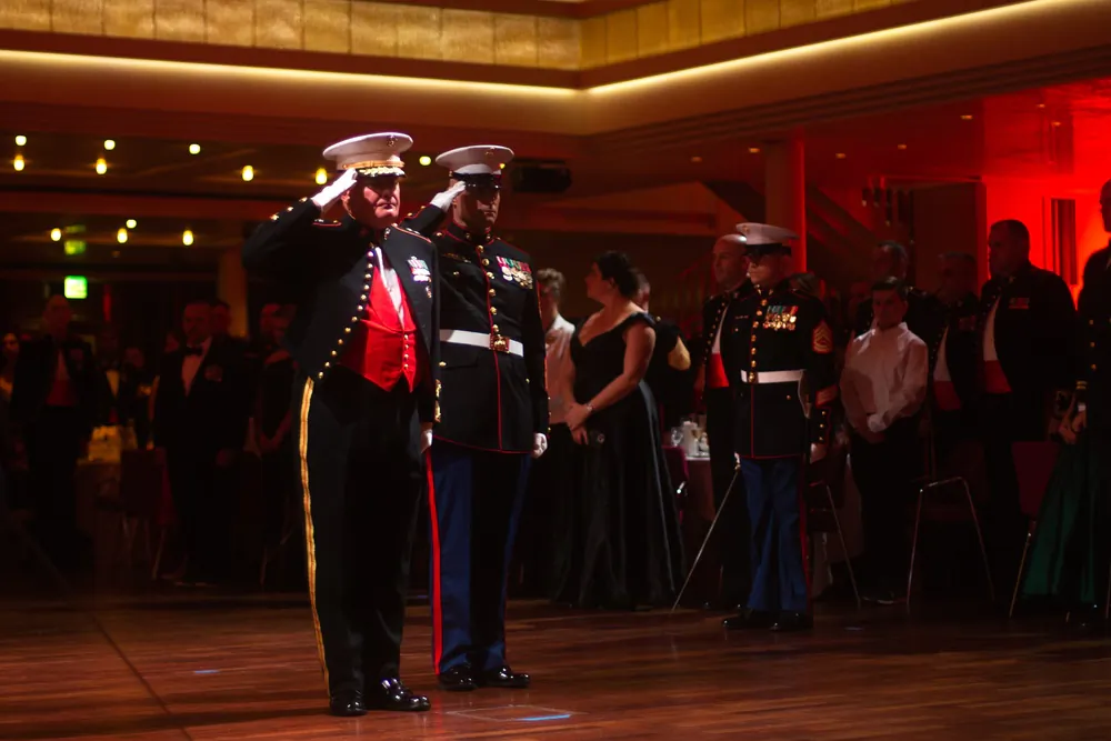U.S. Marine Corps Maj. Gen. Tracy W. King (left), commander of U.S. Marine Corps Forces Europe and Africa (MARFOREUR/AF) and U.S. Marine Corps Sgt. Maj. David M. Elliot (right), sergeant major of MARFOREUR/AF, salute for the playing of the national anthem during the 247th Marine Corps ball ceremony hosted at Kurhaus, Baden-Baden, Germany, on Nov. 27, 2022. (Lance Cpl. Mary Linniman, U.S. Marine Corps)
