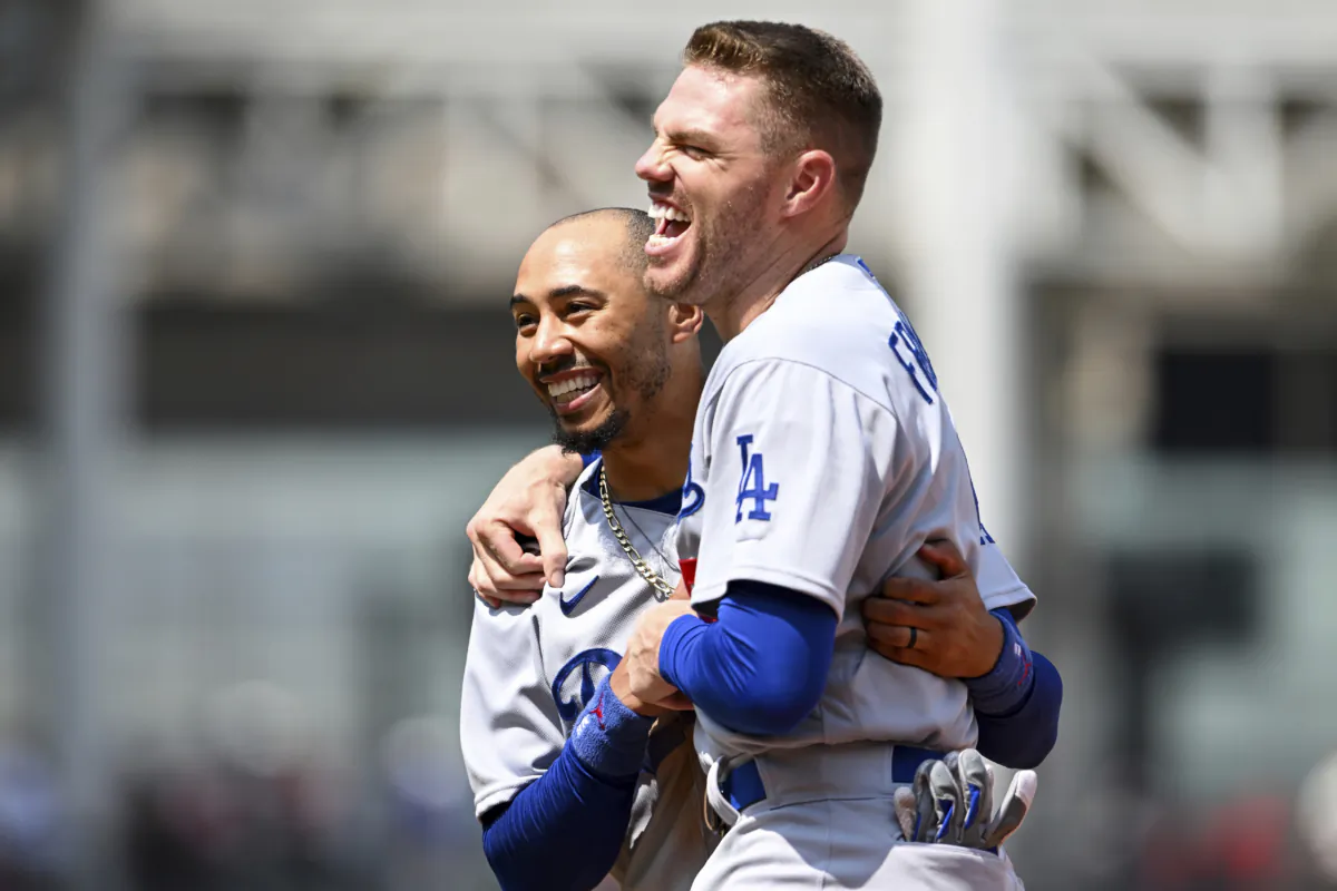 Los Angeles Dodgers' Mookie Betts, left, and Freddie Freeman laugh during the fourth inning against the Cleveland Guardians in Cleveland on Aug. 24, 2023. (Nick Cammett/AP Photo)