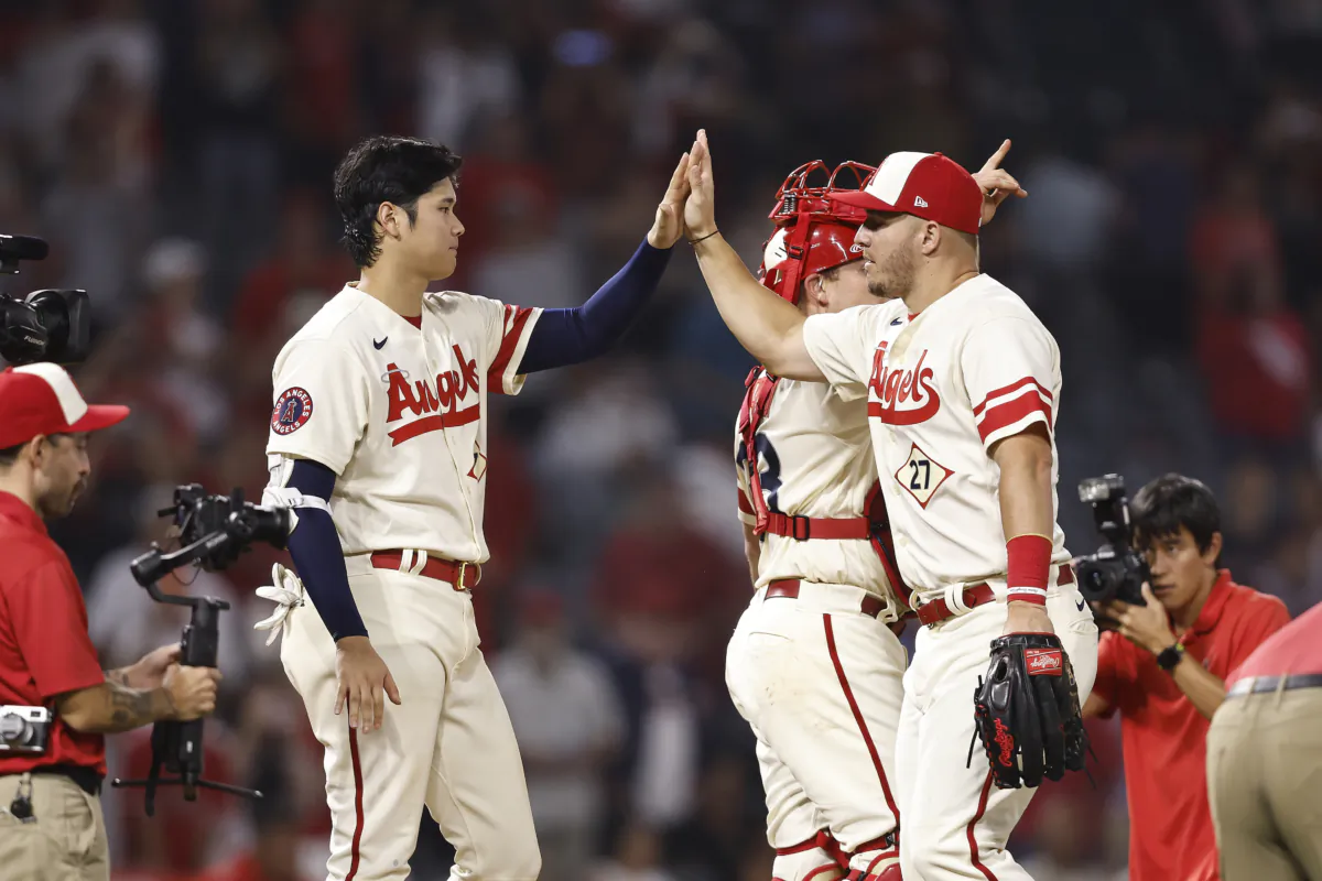 Shohei Ohtani (17) of the Los Angeles Angels celebrates with his teammate Mike Trout (27) after defeating the Oakland Athletics in the ninth inning at Angel Stadium of Anaheim in Anaheim, Calif., on September 29, 2022. (Michael Owens/Getty Images)