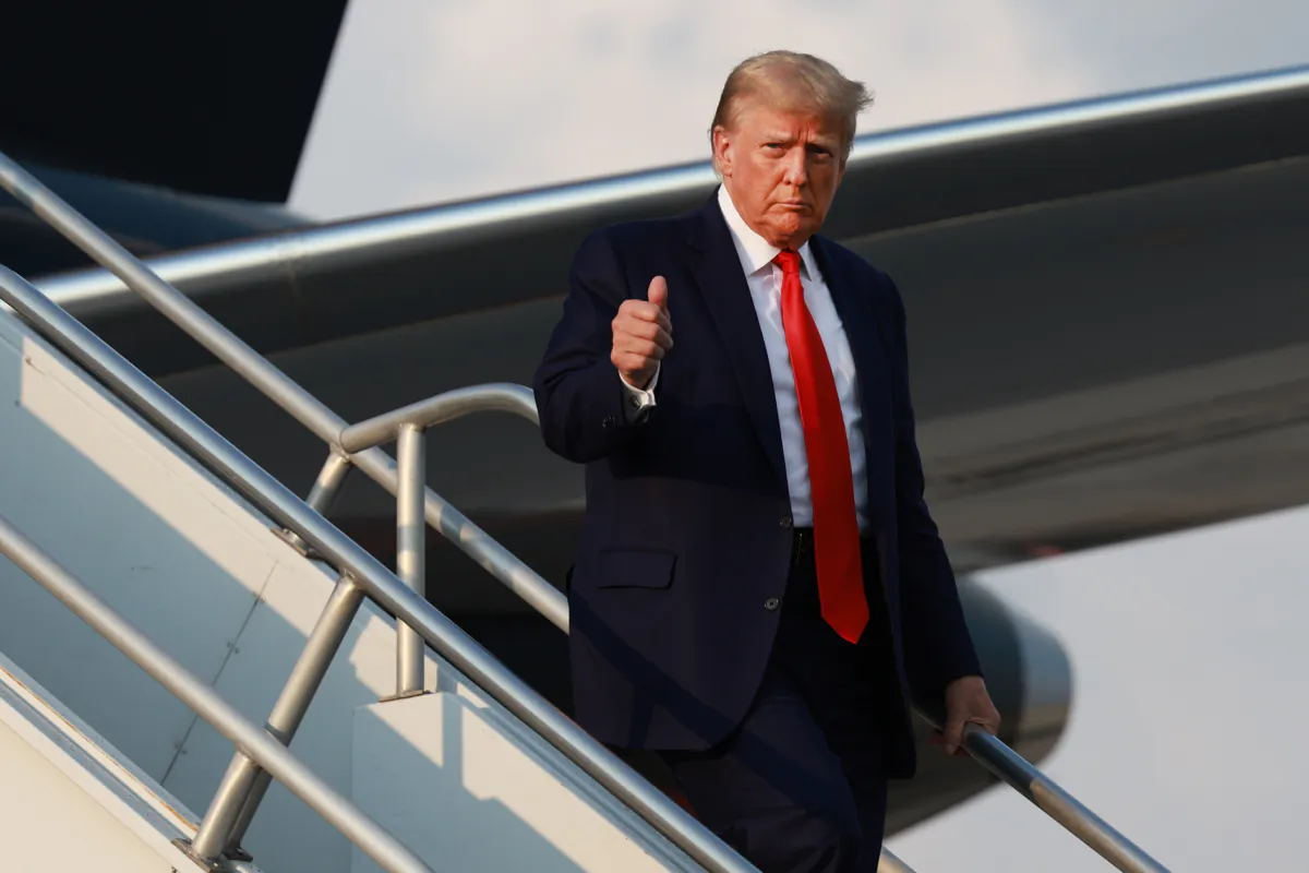 Former President Donald Trump gives a thumbs up as he arrives at Atlanta Hartsfield-Jackson International Airport in Atlanta on Aug. 24, 2023. (Joe Raedle/Getty Images)