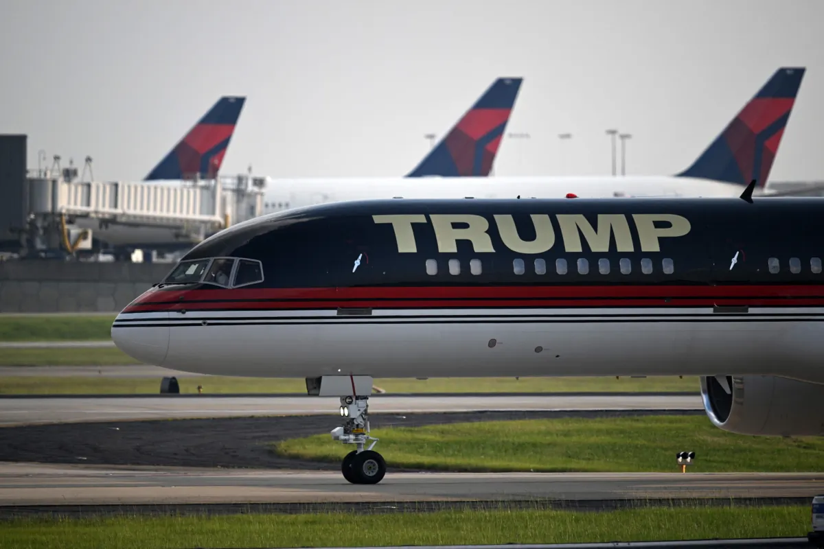 Former President Donald Trump onboard his plane Trump Force One arrives at Atlanta Hartsfield-Jackson International Airport on his way to the Fulton County Jail in Atlanta, Ga., on Aug. 24, 2023. (Andrew Caballero-Reynolds/AFP via Getty Images)