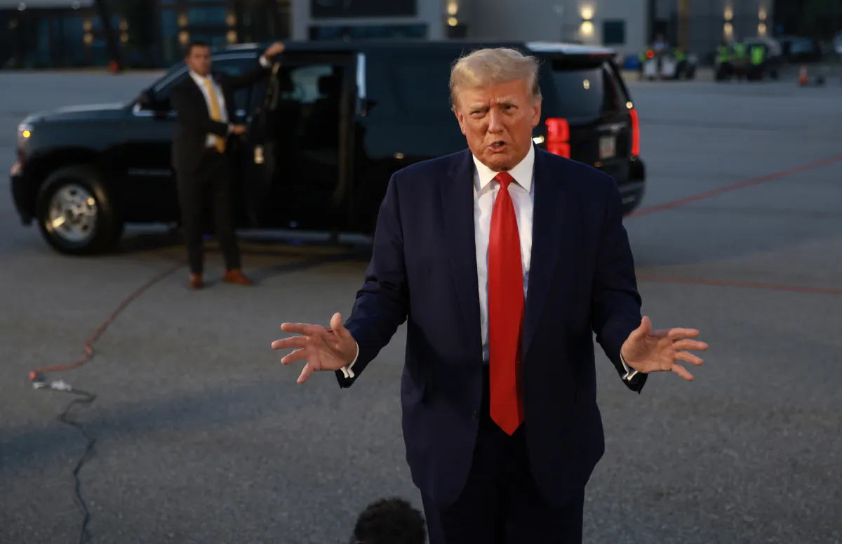 Former President Donald Trump speaks to reporters after being booked at the Fulton County jail on 13 charges related to the 2020 election, in Atlanta, Ga., on Aug. 24, 2023. (Joe Raedle/Getty Images)