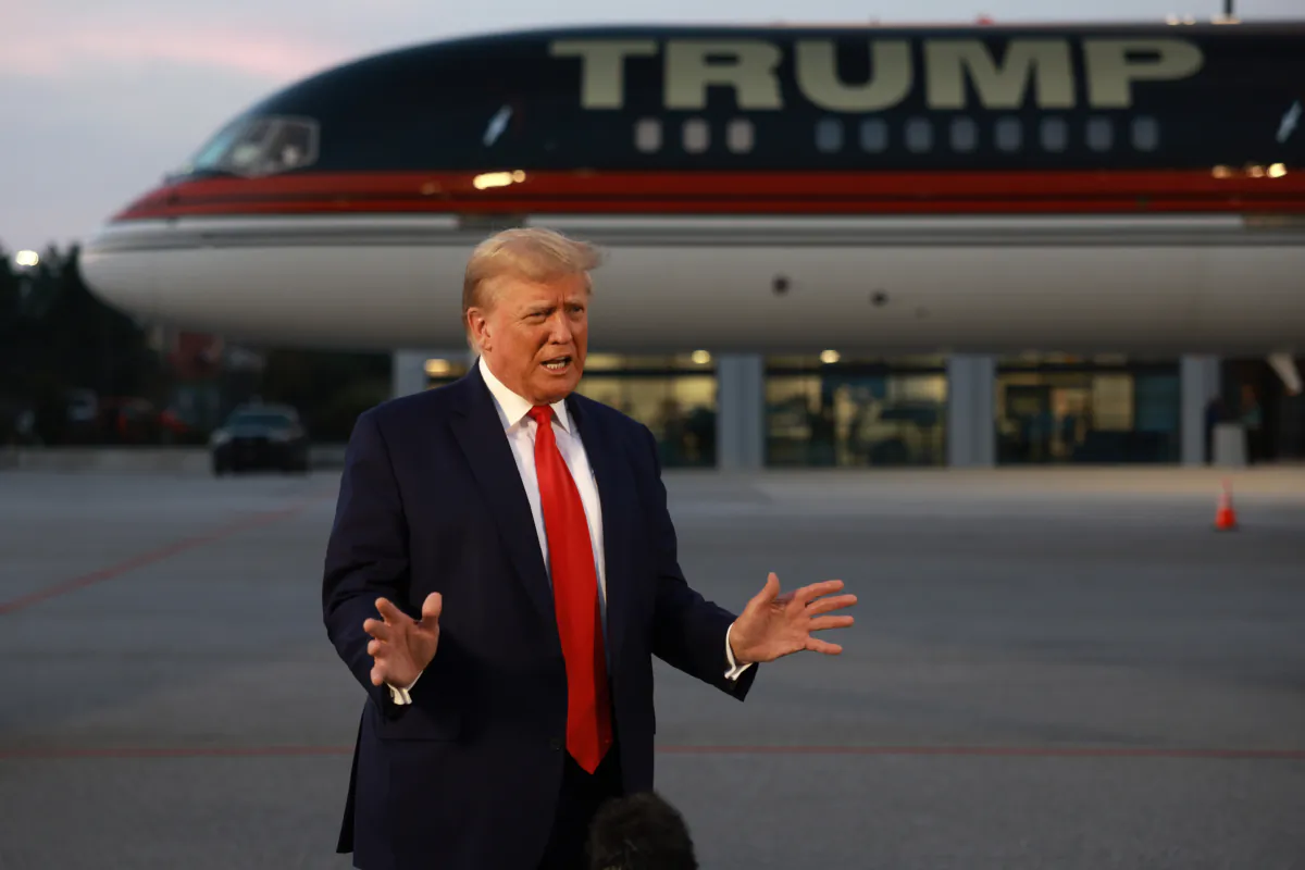 Former President Donald Trump speaks to reporters after being booked at the Fulton County Jail on 13 charges related to the 2020 election, in Atlanta, Ga., on Aug. 24, 2023. (Joe Raedle/Getty Images)