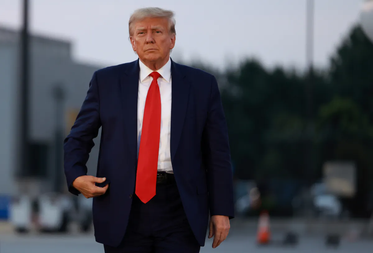 Former President Donald Trump arrives to depart at Atlanta Hartsfield-Jackson International Airport after being booked at the Fulton County Jail in Atlanta, Ga., on Aug. 24, 2023. (Joe Raedle/Getty Images)