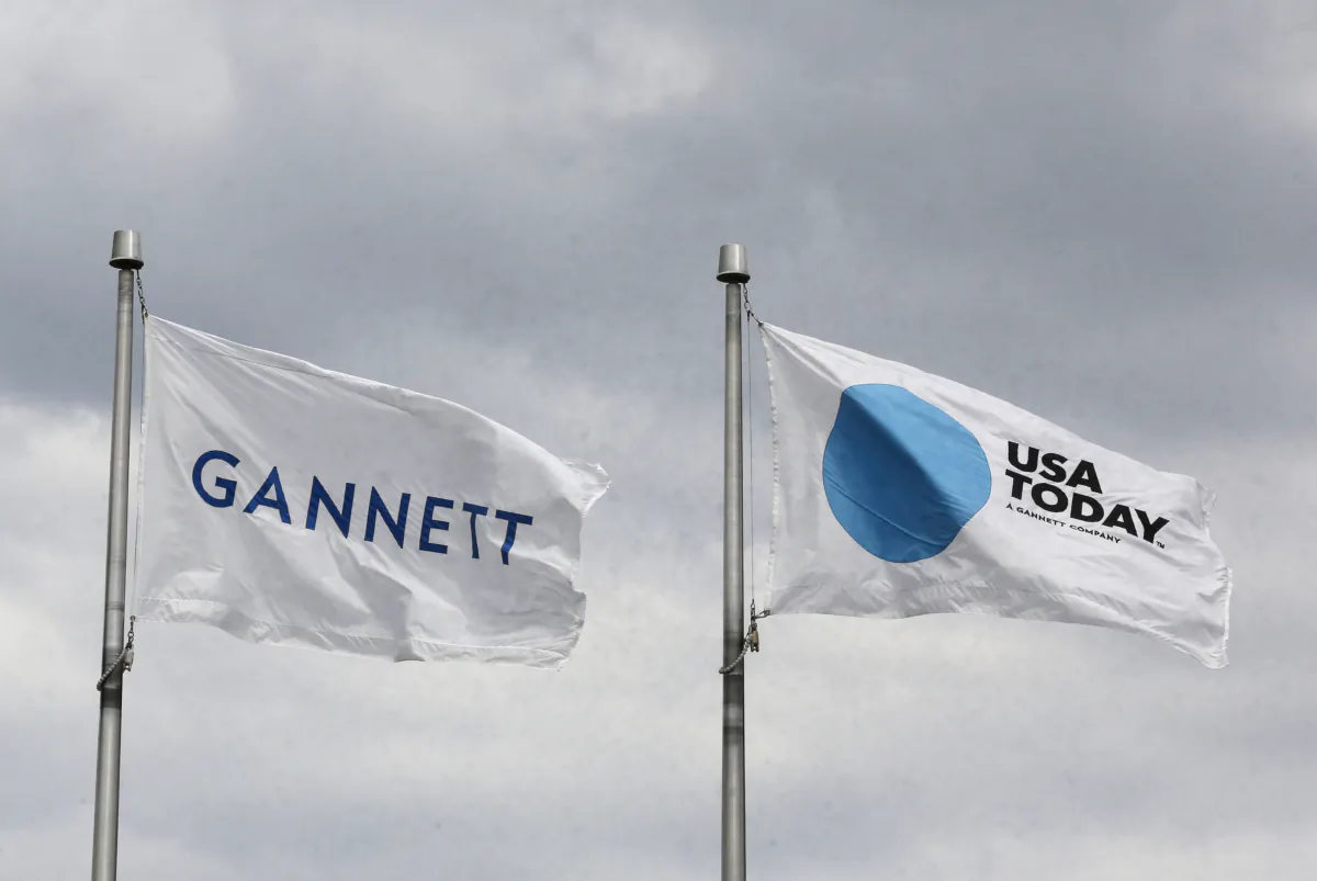 The corporate flags for the Gannett Co. and its flagship newspaper, USA Today, fly outside their corporate headquarters in McLean, Va., on July 23, 2013. (Larry Downing/Reuters)