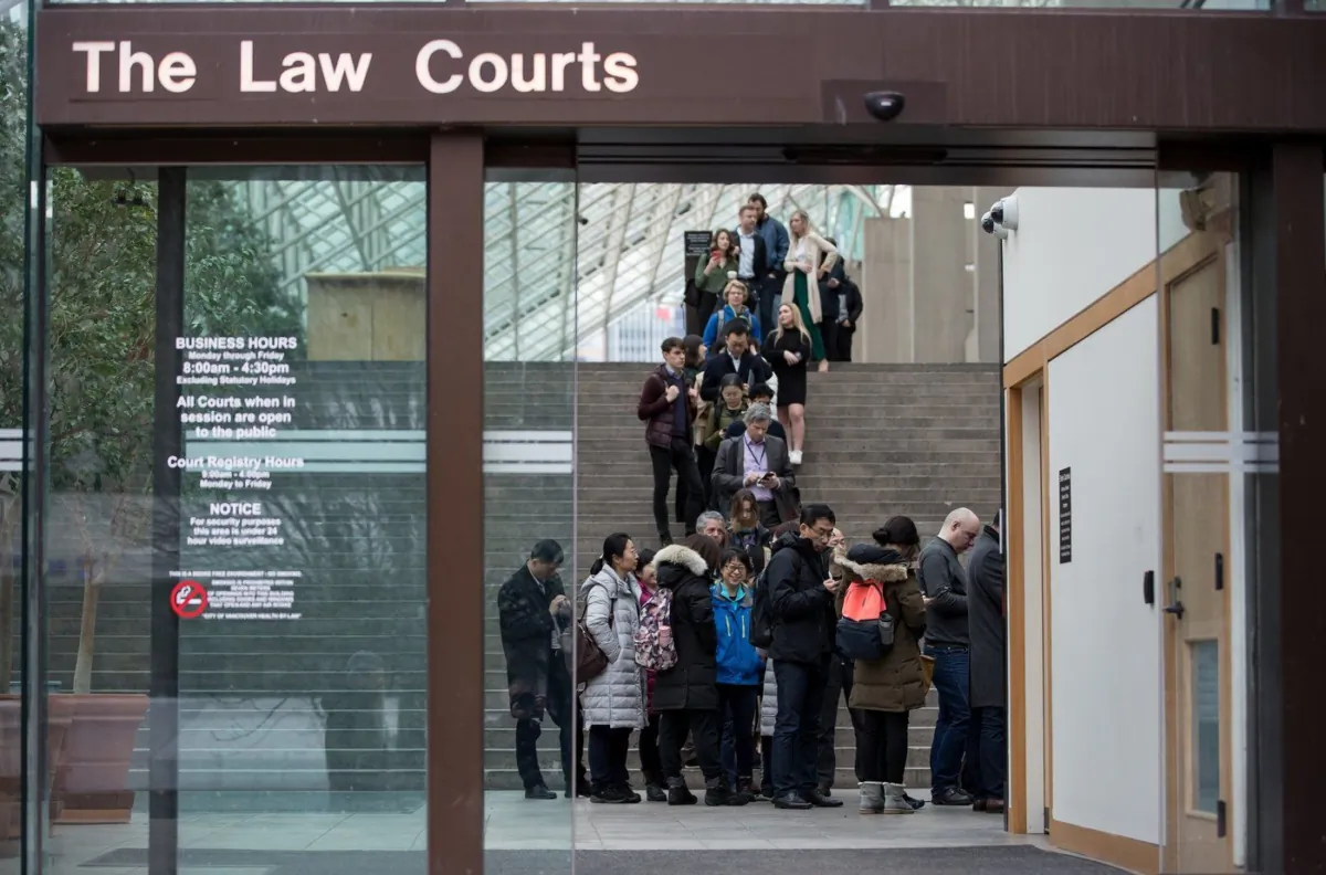 Members of the media and public line up to enter a courtroom at B.C. Supreme Court, in Vancouver, B.C., Jan. 21, 2020. (The Canadian Press/Darryl Dyck)
