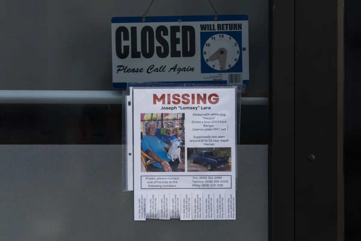 A missing person flyer for Joseph "Lomsey" Lara is posted on the door of a business in a shopping mall in Lahaina, Hawaii, on Aug. 21, 2023. (Jae C. Hong/AP Photo)