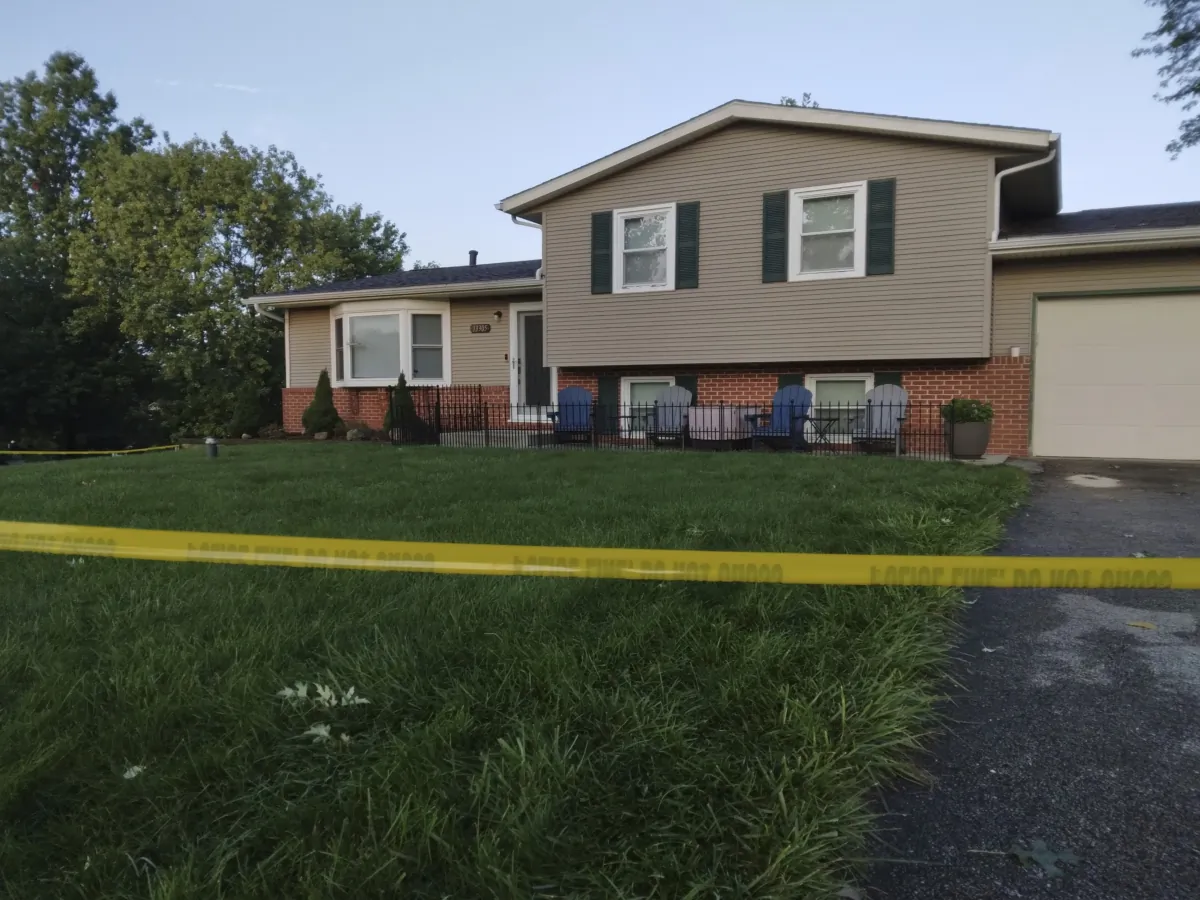 Police tape lines the front yard at a home in Lake Township, Ohio, on Aug. 25, 2023. (Nancy Molnar/The Canton Repository via AP)