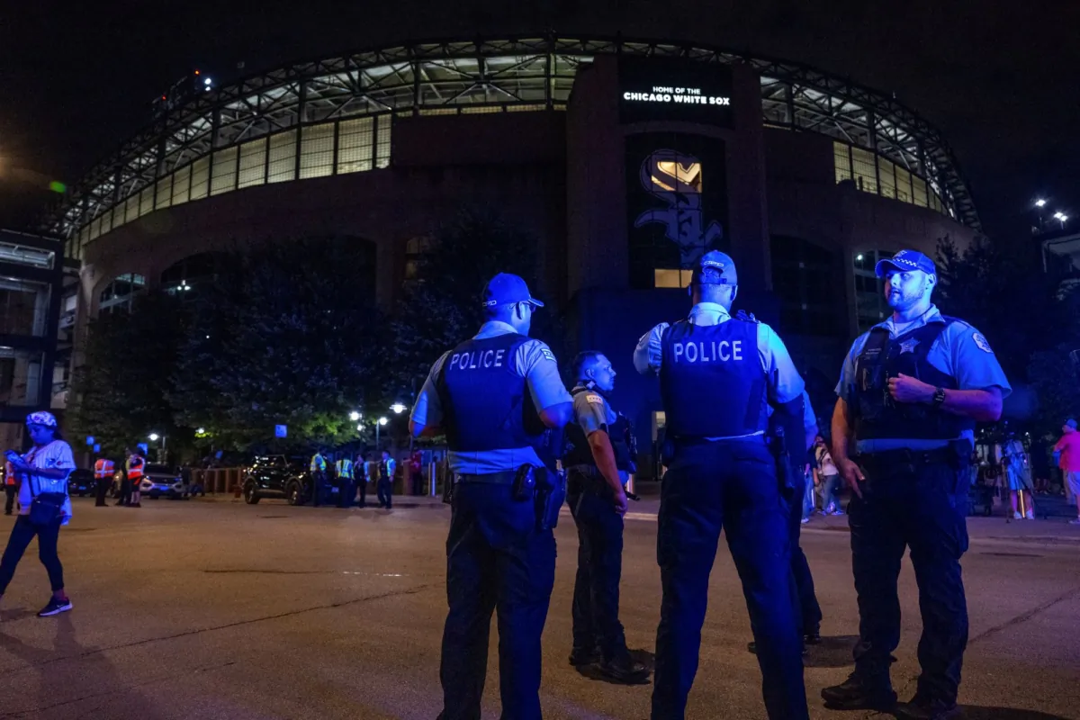 Chicago police officers stand outside Guaranteed Rate Field in Chicago on Aug. 25, 2023. (Tyler Pasciak LaRiviere/Chicago Sun-Times via AP)
