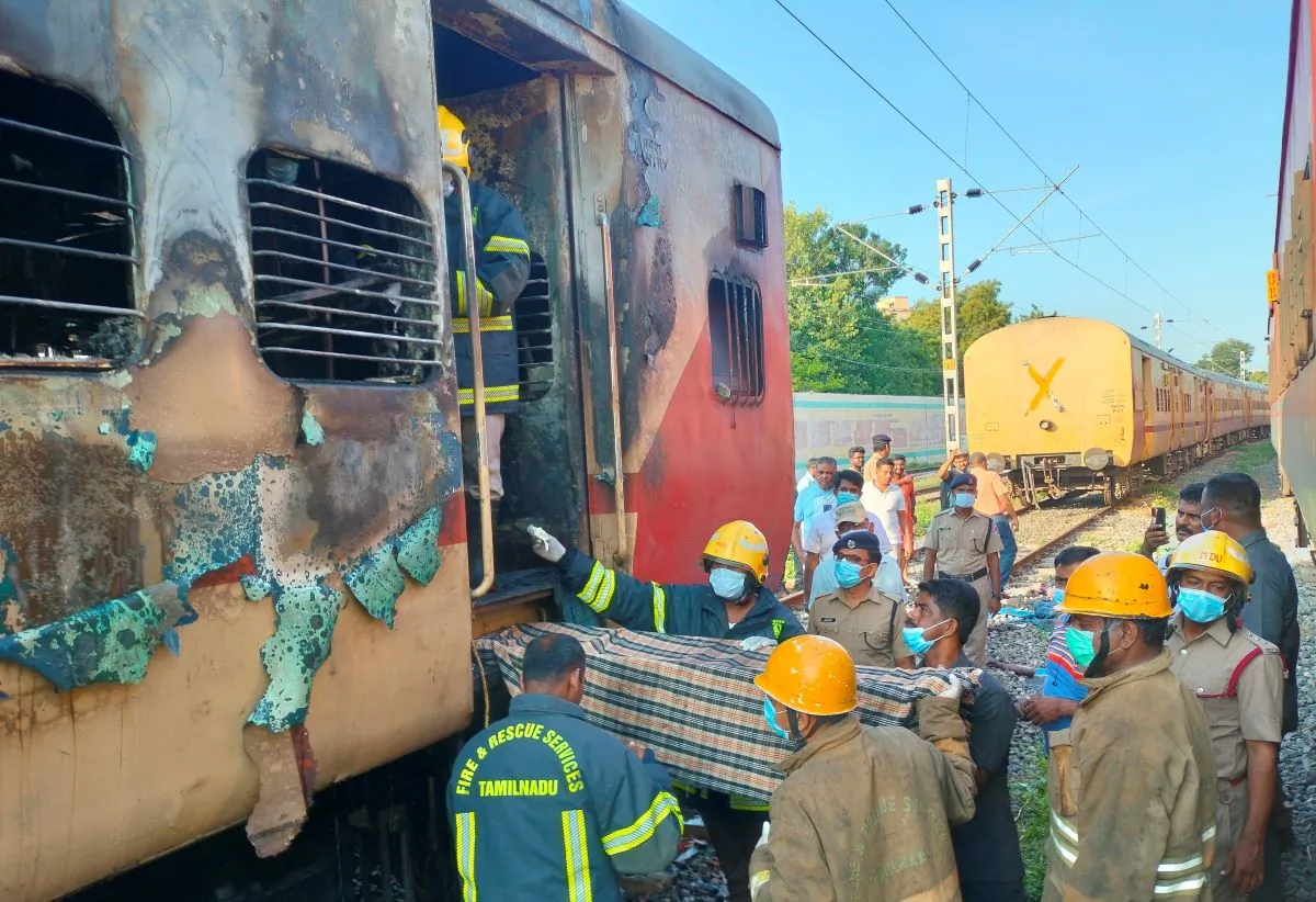 Firefighters hold a stretcher to carry bodies from a train coach where fire erupted in Madurai, in the southern Indian state of Tamil Nadu, on Aug. 26, 2023. (AP Photo)